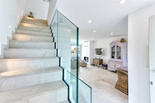 A staircase leads from the open living area to the upper floor
