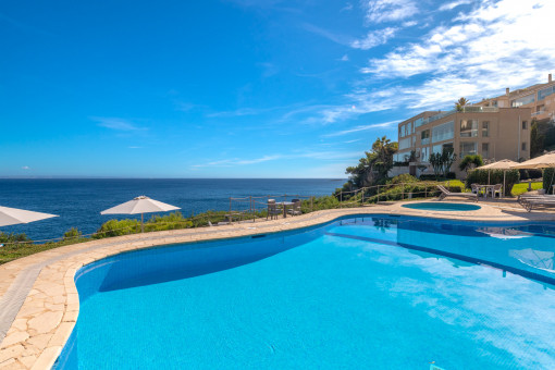 Bright ground floor apartment with spacious sunny terrace, communal pool in first sea line and direct sea access in Cala Vinyas